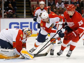 Belle River's Aaron Ekblad, centre, checks Detroit's Tomas Jurco, right, in front of Florida Panthers goalie Roberto Luongo Tuesday at Joe Louis Arena. (AP Photo/Paul Sancya)