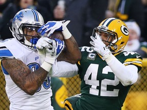 Morgan Burnett (42) of the Green Bay Packers breaks up a pass intended for  Eric Ebron (85) of the Detroit Lions in the second quarter at Lambeau Field on December 28, 2014 in Green Bay, Wisconsin.  (Photo by Chris Graythen/Getty Images)