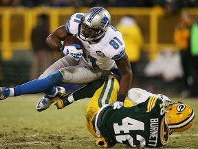 Calvin Johnson #81 of the Detroit Lions scores a touchdown against the defense of  Morgan Burnett #42 of the Green Bay Packers in the second quarter at Lambeau Field on December 28, 2014 in Green Bay, Wisconsin.  (Photo by Chris Graythen/Getty Images)