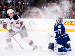 Toronto Maple Leafs goalie Jonathan Bernier, right, gets snowed from New Jersey Devils forward Tuomo Ruutu Thursday. (THE CANADIAN PRESS/Nathan Denette)