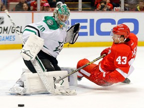 Dallas goalie Jussi Rynnas, left, makes a save on Detroit's Darren Helm Thursday. (AP Photo/Paul Sancya)