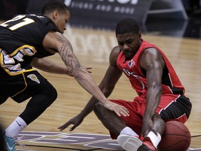 Windsor's Tony Bennett, right, battles London's Adrian Moss at the WFCU Centre. Bennett regained control of the ball and made a pass to a teammate. (NICK BRANCACCIO/The Windsor Star)