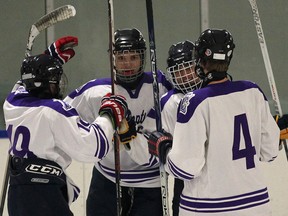 Assumption players celebrate a goal against Cardinal Carter Tuesday at Adie Knox Arena. (DAN JANISSE/The Windsor Star)
