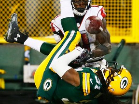 Green Bay's Davon House, bottom, breaks up a pass intended for  Julio Jones of the Atlanta Falcons in the fourth quarter at Lambeau Field Monday. (Photo by Kevin C. Cox/Getty Images)