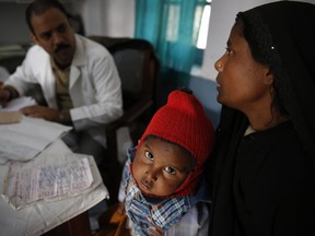 In this file photo, a doctor attends to Anwar, 4, infected with tuberculosis at the Kashi Vidyapith block hospital in Kotawa near Varanasi, India. India has the highest incidence of TB in the world, according to the World Health Organization's Global Tuberculosis Report 2013, with as many as 2.4 million cases. India saw the greatest increase in multidrug-resistant TB between 2011 and 2012. The disease kills about 300,000 people every year in the country. (AP Photo/Rajesh Kumar Singh)