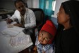 In this file photo, a doctor attends to Anwar, 4, infected with tuberculosis at the Kashi Vidyapith block hospital in Kotawa near Varanasi, India. India has the highest incidence of TB in the world, according to the World Health Organization's Global Tuberculosis Report 2013, with as many as 2.4 million cases. India saw the greatest increase in multidrug-resistant TB between 2011 and 2012. The disease kills about 300,000 people every year in the country. (AP Photo/Rajesh Kumar Singh)