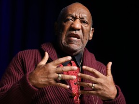 In this Nov. 6, 2013 file photo, comedian Bill Cosby performs at the Stand Up for Heroes event at Madison Square Garden in New York. Cosby resigned Monday, Dec. 1, 2014, as a trustee of Temple University following string of allegations that accused him of drugging and sexually assaulting women over many years. The 77-year-old entertainer has been a highly visible cheerleader of his beloved alma mater in Philadelphia and a board member since 198 (John Minchillo/Invision/AP, File)