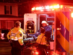 WINDSOR, ONT.: (12/27/14) -- Essex-Windsor paramedics load a patient into an ambulance after a two car collision at the intersection of Campbell Avenue and University Avenue, Saturday, Dec. 27, 2014. The man was assessed and released at the scene, two others were sent to hospital. (RICK DAWES/The Windsor Star)