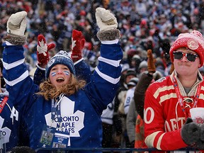 In this file photo, a Leafs fan cheers while a Red Wings fans shakes his head after Toronto's first goal of the  2014 Bridgestone NHL Winter Classic between the Detroit Red Wings and the Toronto Maple Leafs at Michigan Stadium in Ann Arbor, Wednesday, January 1, 2014.  Toronto defeated Detroit 3-2 in a shootout.   (DAX MELMER/The Windsor Star)