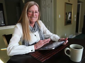 Patricia Laporte, 63, who suffers from COPD, a form of lung disease, answers daily questions about her health on a tablet while having her morning coffee, Monday, Dec. 21, 2014.  Her answers are then monitored by a registered nurse.    (DAX MELMER/The Windsor Star)