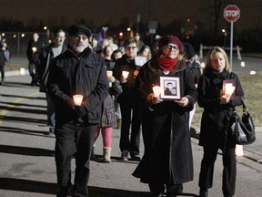 Parents of Nicholas Katsilas, Dean, left, and Pat Katsilas, centre, walk as part of a memorial procession Sunday, Dec. 14, 2014, at the WFCU Centre. A vigil was held in memory of children who have died. (RICK DAWES/The Windsor Star)
