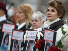 Nadia Popovich, right, joins other women for a memorial ceremony held by Unifor Local 444 for the National Day of Remembrance and Action on Violence Against Women Saturday, Dec. 6, 2014.  The ceremony was held at Marylou's Memorial on Chrysler Centre outside the Windsor Assembly Plant.  (DAX MELMER/The Windsor Star)