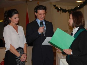 Amherstburg Mayor Aldo DiCarlo, centre, is sworn in by the Honourable Susan Whelan, Ontario Justice of the Peace, right, while his wife, Laura DiCarlo, looks on Monday, Dec. 1, 2014 at the Verdi Club. (JULIE KOTSIS/The Windsor Star)