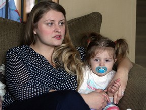 Karina Mihan is photographed with her daughter Abigail in their home in Fort McMurray, Alberta on Saturday, December 6, 2014. Karina and her husband John left Windsor for better opportunities in Alberta and have since started a family and plan to stay. (TYLER BROWNBRIDGE/The Windsor Star)