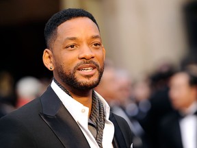 In this March 2, 2014 file photo, Will Smith arrives at the Oscars at the Dolby Theatre in Los Angeles. Smith, Jared Leto and Tom Hardy are suiting up for DC Comics’ supervillain team-up film “Suicide Squad.” Warner Bros. confirmed the much anticipated casting of the film in an announcement Tuesday, Dec. 2, 2014.  (Photo by Chris Pizzello/Invision/AP, File)