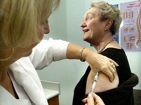 Gwen Balance of Michigan receives a flu shot in Windsor in this 2004 file photo. (Nick Brancaccio / The Windsor Star)