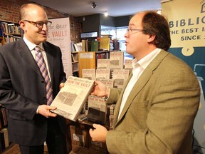 A media conference was held at the Biblioasis book store in Windsor, ON. on Thursday, Dec. 18, 2014 to  announce that the From the Vault book has sold through its first printing. Mayor Drew Dilkens (L) was presented with a copy of the book from author and publisher Daniel Wells during the event. (DAN JANISSE/The Windsor Star)