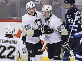 Pittsburgh Penguins' Beau Bennett (19) and Sidney Crosby (87) are two of several NHL players suffering from the mumps, a virus that has been pretty much contained for years, thanks to vaccinations. THE CANADIAN PRESS/John Woods