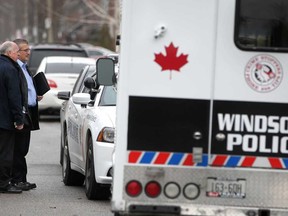 Windsor police detectives work at the scene of a homicide at 1564-66 Benjamin Ave., Sunday, Dec. 14, 2014.  (DAX MELMER/The Windsor Star)