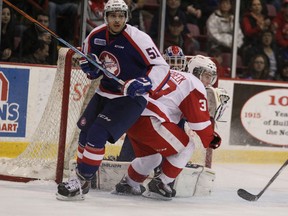 Spitfires defenceman Jalen Chatfield, left, battles with Sault Ste. Marie winger Hayden Verbeek during OHL action on Sunday, Dec. 14, 2014 in Sault Ste. Marie. (Photo courtesy of the Sault Star)