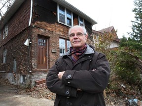 Kevin Flood is shown Tuesday, Dec. 2, 2014, in front of the property he owns in the 300 block of Indian Rd. in Windsor, ON. He is suing the city, saying they are preventing him from doing what he wishes with the home. (DAN JANISSE/The Windsor Star)