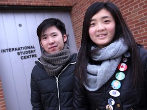 International students, Beiheng Duan, left, and WinShi Wong are pictured outside the International Student Centre at the University of Windsor, Saturday, Dec. 20, 2014. The university is appealing to the public for more volunteers to take in an international student to share the Christmas hoidays. (DAX MELMER/The Windsor Star)
