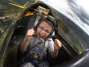Shane Jensen, 8, is full of excitement as he takes a ride in a vintage de Havilland Canada DHC-1 Chipmunk for the Top Gun: Kids with Cancer Take Flight at the Windsor International Airport, Saturday, Sept. 6, 2014.  (DAX MELMER/The Windsor Star)
