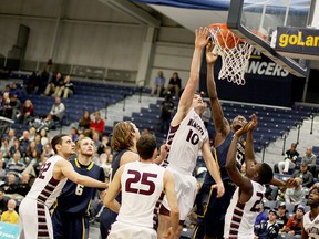 University of Windsor Lancer Rotimi Osuntola Jr., 12, scores two in the third quarter Saturday night at the St. Denis Centre. The Lancers faced off against the McMaster Marauders. (RICK DAWES/The Windsor Star)