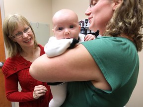 Midwife Karen McKenzie checks on 2 month-old Isabella Brett as her mom Samantha Brett looks on at clinic in Kingsville ON. on Tuesday, Dec. 2, 2014. (DAN JANISSE/The Windsor Star)