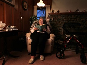 Minnie DeSantis, 88, reads in the comfort of her own home in Kingsville, Friday, Dec. 5, 2014.  DeSantis suffered a heart attack last November and was back in her home by May due to a program at Leamington District Memorial Hospital called assess and restore.  (DAX MELMER/The Windsor Star)