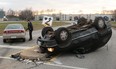 A Windsor police officer works at the scene of a two-car collision at the intersection of Jefferson Blvd. and Quality Way, Saturday, Dec. 6, 2015.  One person was taken to hospital with unknown injuries.  (DAX MELMER/The Windsor Star)