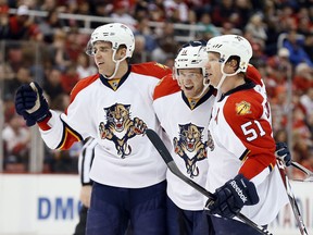Belle River native Aaron Ekblad, left, celebrates a goal with Panther teammates Jonathan Huberdeau, centre, and Brian Campbell against the Detroit Red Wings in Detroit Friday, Dec. 12, 2014. (AP Photo/Paul Sancya)