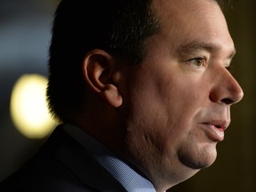 In this file photo, Christian Paradis, Minister of International Development and Minister for La Francophonie holds a press conference in the foyer of the House of Commons on Parliament Hill in Ottawa on Monday, December 2, 2013 regarding Canada's support for a Global Fund initiative aimed at fighting against AIDS, tuberculosis and malaria. THE CANADIAN PRESS/Sean Kilpatrick