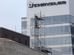 Workers install scaffolding atop the Paul Martin building on Wed. Dec. 10, 2014, in downtown Windsor, ON. (DAN JANISSE/The Windsor Star)