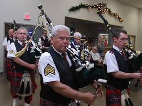 Pipe major Bryon Knight, centre, leads the Sun Parlour Pipes and Drums during a benefit performance at the Royal Canadian Legion - Branch 594 in LaSalle, Sunday, Dec. 14, 2014. The band is trying to raise funds for their trip to Holland for the 70th anniversary of the Liberation of Holland.  (DAX MELMER/The Windsor Star)