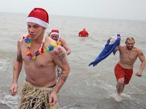 Drew Gaudette, 29, joins a dozen participants in the 12th annual Polar Bear Dip at Colchester Beach, Saturday, Dec. 13, 2014.  Money raised goes towards the Optimist Club of Amherstburg and the Harrow Kinsmen.  (DAX MELMER/The Windsor Star)