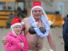 Keith Bridgen and his daughter, Grace Bridgen, 10, part in the 12th annual Polar Bear Dip at Colchester Beach, Saturday, Dec. 13, 2014.  Money raised goes towards the Optimist Club of Amherstburg and the Harrow Kinsmen.  (DAX MELMER/The Windsor Star)