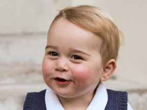 In this photo provided by The Duke and Duchess of Cambridge and taken in late Nov. 2014, Britain's Prince George poses for a photograph in a courtyard at Kensington Palace, London.