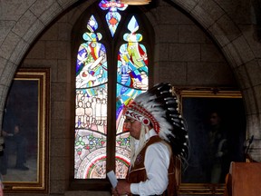 Chief Wilton Littlechild, a Commissioner of the Truth and Reconciliation Committee, stands in front of stained a glass window in House of Commons foyer, during a dedication ceremony commemorating the legacy of former Indian Residential school students and their families on Parliament Hill in Ottawa, Monday November 26, 2012. THE CANADIAN PRESS/Fred Chartrand ORG XMIT: FXC113 ORG XMIT: POS1211261319374595