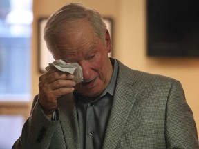 Karl Straky wipes a tear during a room dedication ceremony on Monday, Dec. 15, 2014, at the Windsor Regional Hospital Ouellette Campus. Straky and his family donated money to redesign and furnish a waiting room in the hospital in honour of his wife Kathleen Straky who passed away in July.  (DAN JANISSE/The Windsor Star