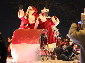Mr. and Mrs. Claus wave to parade goers, Saturday, December 6, 2014, in front of Atkinson Park on Riverside Drive West. This year celebrates the 46th anniversary of the Windsor Santa Claus Parade. (RICK DAWES/The Windsor Star)