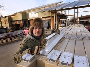 Aleks Stevanov is shown at his Windsor, ON. home on in the 4000 block of Baseline Rd. on Thursday, Dec. 11 2014. Some of his neighbours are upset with the solar panels he is installing on his house.  (DAN JANISSE/The Windsor Star)