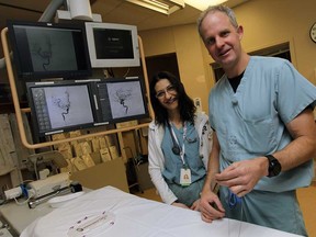 Dr. Sophia Thomas and Dr. Jack Speirs hold up a stent that is used in patients suffering from a stroke at Windsor Regional Hospital Ouellette Campus in Windsor on Monday, December 22, 2014.   (TYLER BROWNBRIDGE/The Windsor Star)