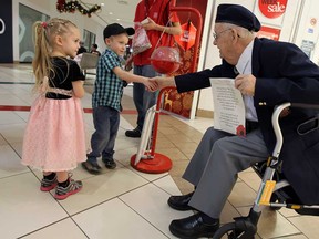 Karlin and Dylan Mellow are greeted by Raymond Pease as veterans helped the Salvation Army with their annual kettle campaign at the Devonshire Mall in Windsor on Tuesday, December 23, 2014.    (TYLER BROWNBRIDGE/The Windsor Star)