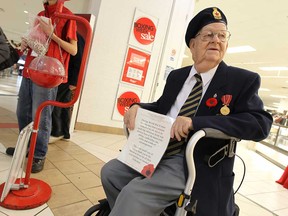 Raymond Pease joins holds a sign as veterans helped the Salvation Army with their annual kettle campaign at the Devonshire Mall in Windsor on Tuesday, December 23, 2014.    (TYLER BROWNBRIDGE/The Windsor Star)