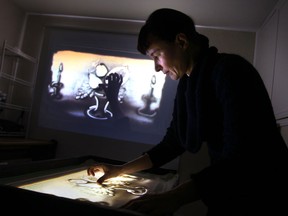 Artist Yelena Simone performs live art sand animation earlier this week. (JASON KRYK / The Windsor Star)