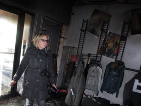 Sharon Jones, owner of Towne Shoppe on Main Street in Kingsville, surveys the damage following a $500,000 fire which destroyed the contents of the men's and women's fashion store, January 1, 2015. (NICK BRANCACCIO/The Windsor Star)