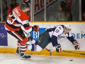 Tecumseh native Sam Studnicka (L) checks Spitfires forward Anthony Stefano into the boards in the first period during OHL action at TD Place Arena in Ottawa on January 9, 2015. (Wayne Cuddington/Ottawa Citizen)