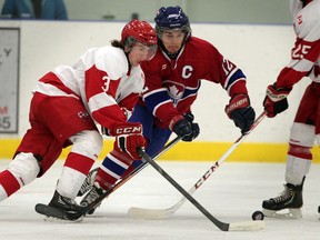 Mooretown Flags' Ryan Lyle, left, carries the puck in front of Lakeshore Canadiens' Sebastian Kanally Jr. C hockey action at Atlas Tire Centre in Lakeshore Friday January 2, 2015. (NICK BRANCACCIO/The Windsor Star)