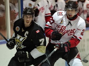 LaSalle's Brett Langlois, left, glances over his shoulder as Leamington's Travis Campbell approaches during junior B hockey action at the Vollmer Centre Wednesday January 7, 2015. (NICK BRANCACCIO/The Windsor Star)